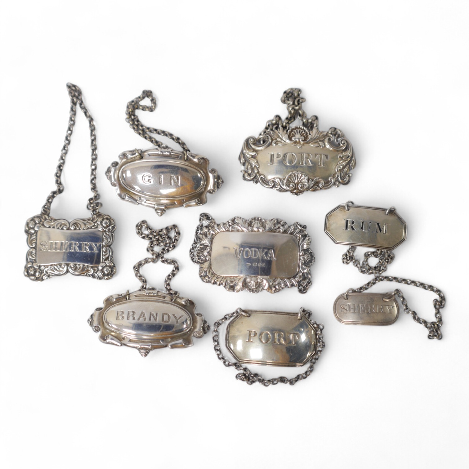 A collection of eight George III and later silver wine labels, including octagonal Port by Thomas Oliphant, London, 1792, 45mm. Condition - fair